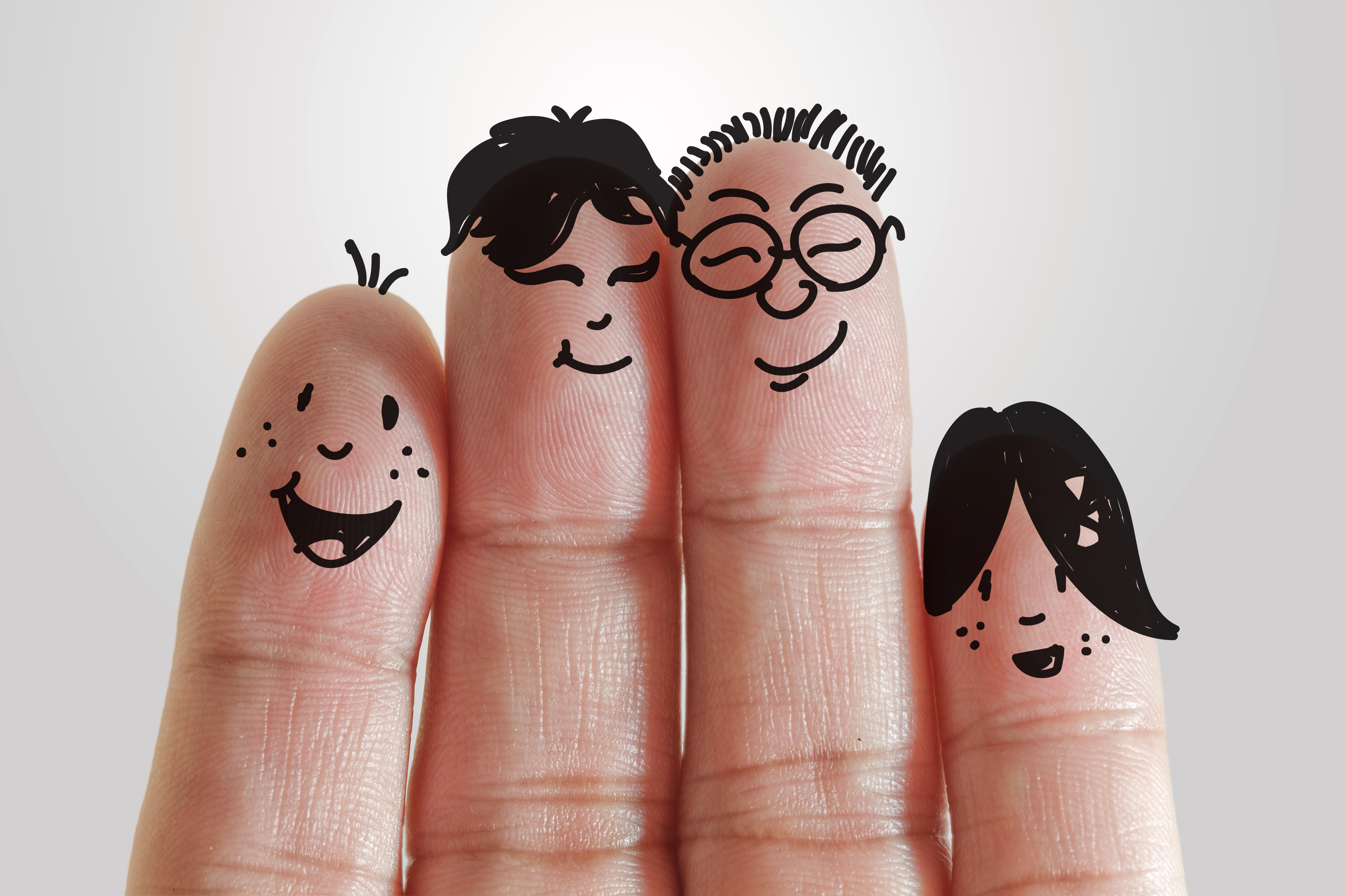 happy family with painted smiley on human fingers